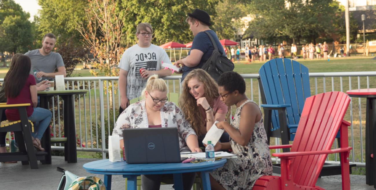 A group of students sitting at a table outside Jefferson Student Union